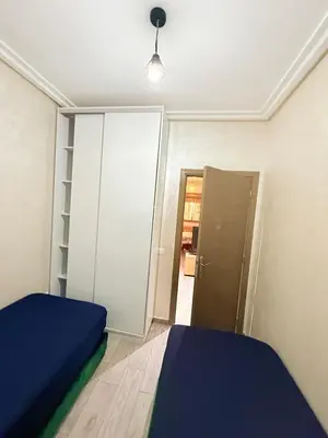 a bedroom with a bed and a closet and a door at N7 Confort Cosy Près De Gueliz in Marrakech