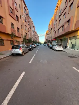 an empty city street with parked cars and buildings at N7 Confort Cosy Près De Gueliz in Marrakech