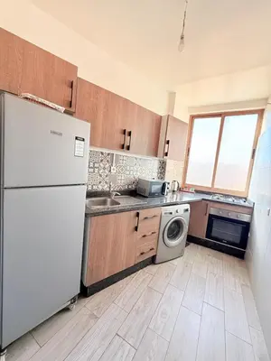 a kitchen with a white refrigerator and a dishwasher at N7 Confort Cosy Près De Gueliz in Marrakech