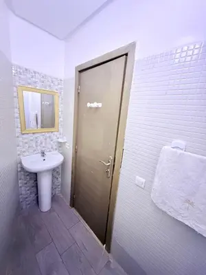 a bathroom with a sink and a shower with a door at N7 Confort Cosy Près De Gueliz in Marrakech