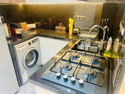 a kitchen with a stove and a washing machine at Appartement à Marrakech in Marrakech