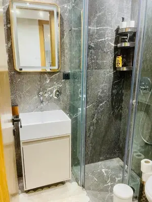 a bathroom with a shower with a sink and a toilet at Appartement à Marrakech in Marrakech