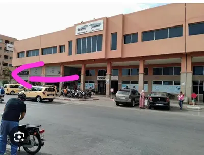 a man on a motorcycle in front of a building at Le Confortable a 15mn de L'aéroport interdit au couples non marié in Marrakech