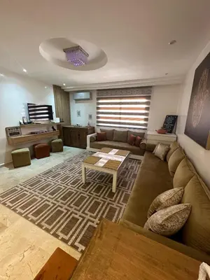 a living room with a couch and a table at Le Confortable a 15mn de L'aéroport interdit au couples non marié in Marrakech
