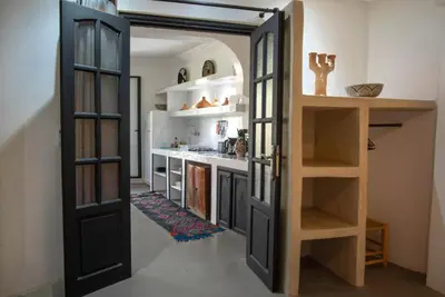 a kitchen with a door open to a kitchen with a counter at Villa Em in Marrakech