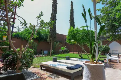 a patio with a couch and plants in a yard at Villa Em in Marrakech