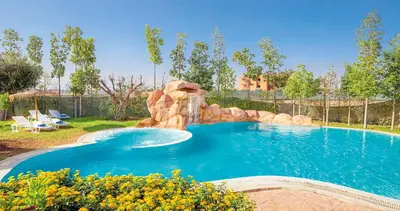 a large swimming pool with a water slide in a yard at Modern Oasis with Waterpark in Marrakech