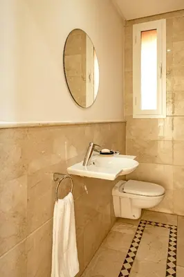 a bathroom with a sink and a toilet and a mirror at Modern Oasis with Waterpark in Marrakech