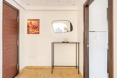 a hallway with a glass table and a mirror at Sojori Majorelle piscine et parking in Marrakech