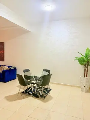 a table and chairs in a room with a plant at Charmant Studio B5 & Bel Terrasse in Marrakech