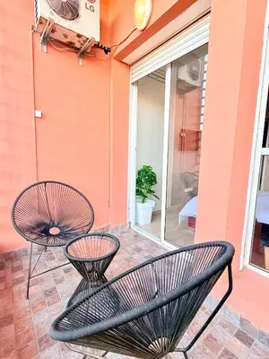 a patio with two chairs and a window at Charmant Studio B5 & Bel Terrasse in Marrakech