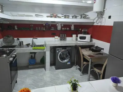 a kitchen with a washing machine and a stove at 5 min Aéroport Appartement avec Terrasse et Grand Appartement in Marrakech