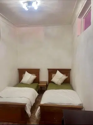 two beds in a small room withacersacers at 5 min Aéroport Appartement avec Terrasse et Grand Appartement in Marrakech