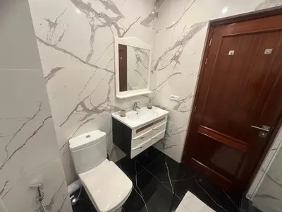 a bathroom with a toilet and a sink and a mirror at Dar Zoubida in Marrakech