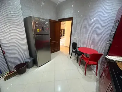 a kitchen with a refrigerator and a table and chairs at Dar Zoubida in Marrakech