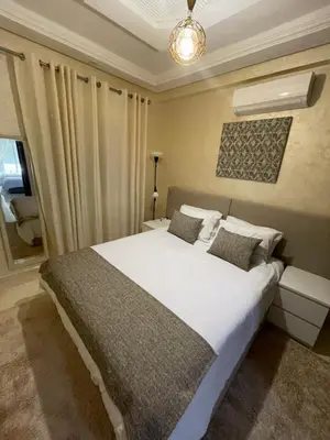 a bedroom with a large white bed and a window at Élégant appart 2chambre, terrasses,proche Gueliz&parking in Marrakech