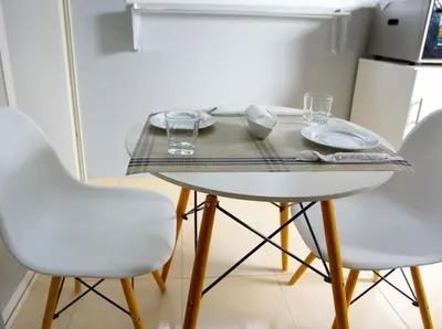 a table with two chairs and a table with glasses on it at Élégant appart 2chambre, terrasses,proche Gueliz&parking in Marrakech
