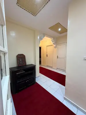 an empty room with a red carpet and a hallway at Appartement Salia à Guéliz Marrakech in Marrakech