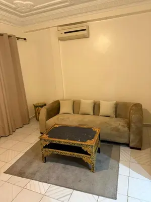 a living room with a couch and a coffee table at Appartement Salia à Guéliz Marrakech in Marrakech