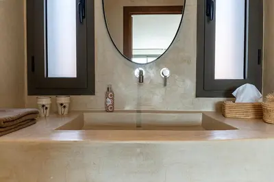a bathroom with a large sink and a mirror at Villa 61 in Marrakech