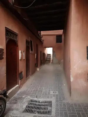an empty alley with a staircase in an old building at BAHIA BIKE APPART 1 - Terrasse in Marrakech