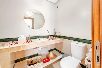 a bathroom with a toilet and a sink and a mirror at la cocon paisible de Marrakech in Marrakech
