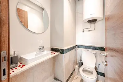 a bathroom with a toilet and a sink and a mirror at la cocon paisible de Marrakech in Marrakech