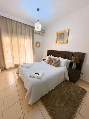 a bedroom with a large bed with white sheets at Ambre in Marrakech