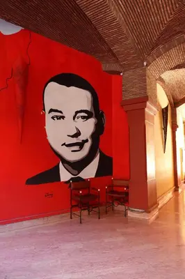 a large painting of a man on a red wall at Ambre in Marrakech