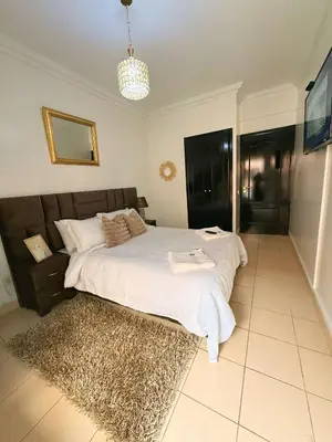 a bedroom with a large bed and a rug at Ambre in Marrakech