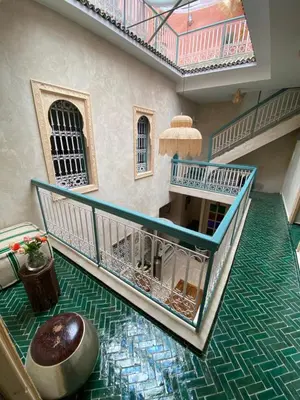 a room with a floor with green tiles and stairs at Riad Dar Khalti Privatisation in Marrakech