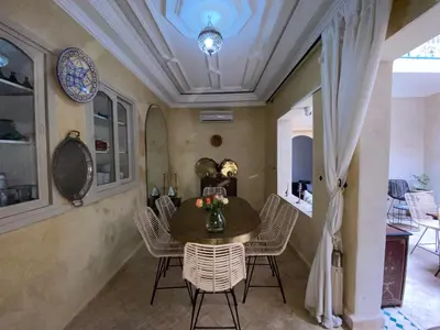 a dining room with a table and chairs at Riad Dar Khalti Privatisation in Marrakech