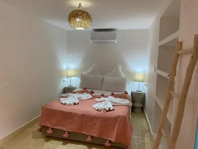a bedroom with a bed with two dolls on it at Riad Dar Khalti Privatisation in Marrakech