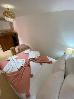 a bedroom with a bed with two robes on it at Riad Dar Khalti Privatisation in Marrakech