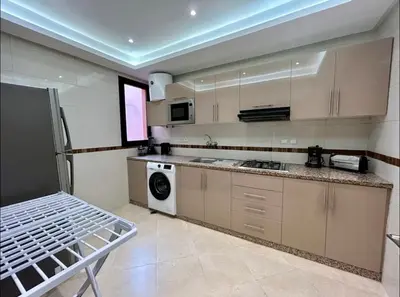 a kitchen with a refrigerator and a dishwasher at Chic Appartement Marrakech in Marrakech