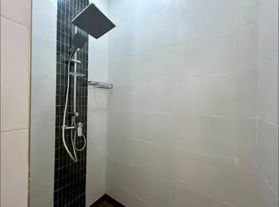 a shower with a black and white tile wall at Chic Appartement Marrakech in Marrakech