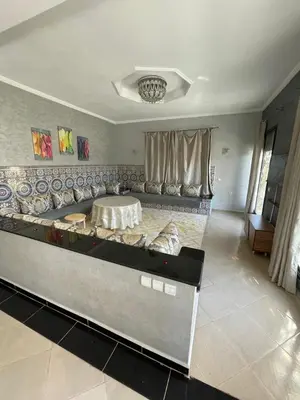 a living room with a table and a couch at Deluxe Private Villa in Marrakech