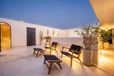 a room with chairs and a table in a building at Riad Nayl Medina & Spa in Marrakech