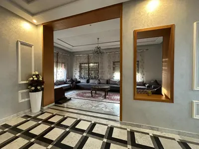 a living room with a mirror and a couch at Villa à la palmeraie in Marrakech