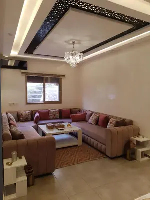 a living room with a couch and a table at Appartement aux portes de Marrakech in Marrakech