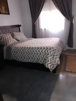 a bedroom with a bed and a window at Appartement aux portes de Marrakech in Marrakech