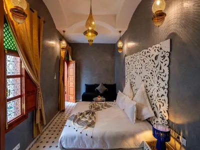 a bedroom with a large bed in a room at Riad Dar Al-Famila & Spa in Marrakech