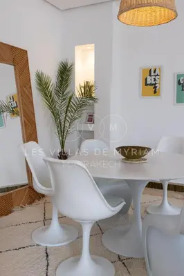 a white dining room with a white table and chairs at Dar Nadim sur le Golf de Samanah in Marrakech