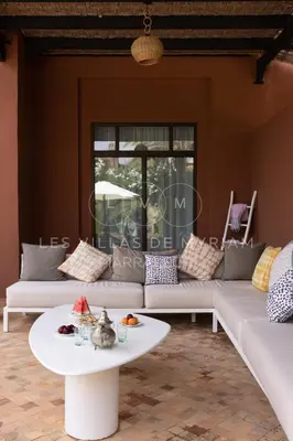 a living room with couches and a coffee table at Dar Nadim sur le Golf de Samanah in Marrakech