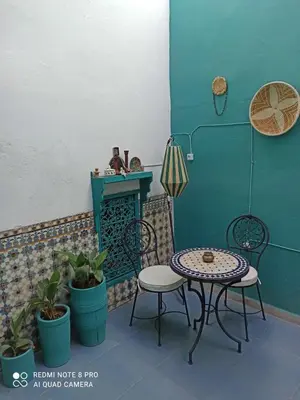 a patio with two tables and a table and chairs at Riad rajad Marrakech in Marrakech
