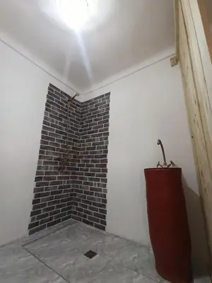a corner of a room with a brick wall at Riad rajad Marrakech in Marrakech