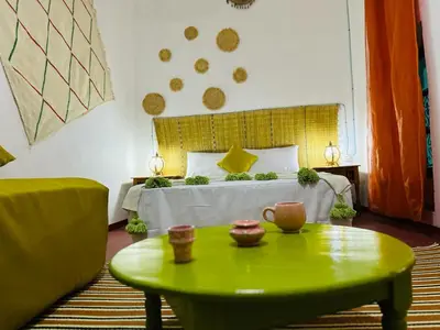 a bedroom with a bed and a green coffee table at Riad rajad Marrakech in Marrakech