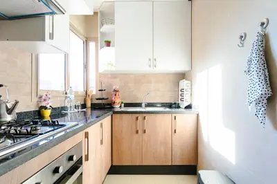 a kitchen with white cabinets and a sink at Crystal Luxury Marrakech Prestigia in Marrakech