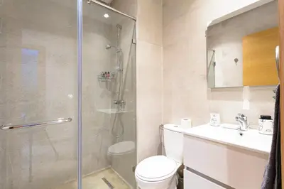 a bathroom with a shower and a toilet and a sink at Crystal Luxury Marrakech Prestigia in Marrakech