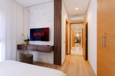 a bedroom with a bed and a television on a wall at Crystal Luxury Marrakech Prestigia in Marrakech